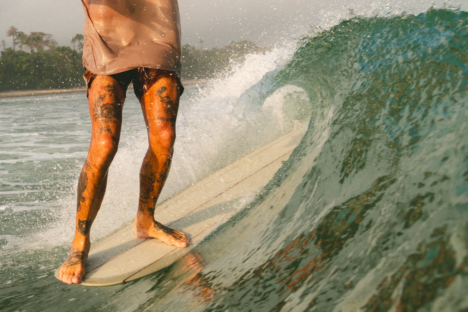 surfer doing hang 5 on a classic longboard surfboard, perfect wave in indonesia, surfboards for sale in bali