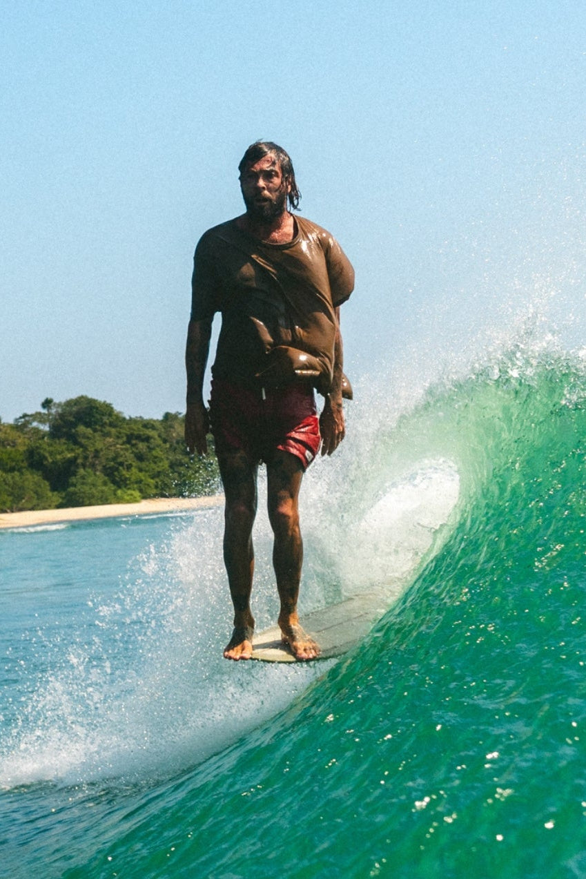 person surfing longboard doing hang 10 on a wave, surfboards and longboards for sale in bali