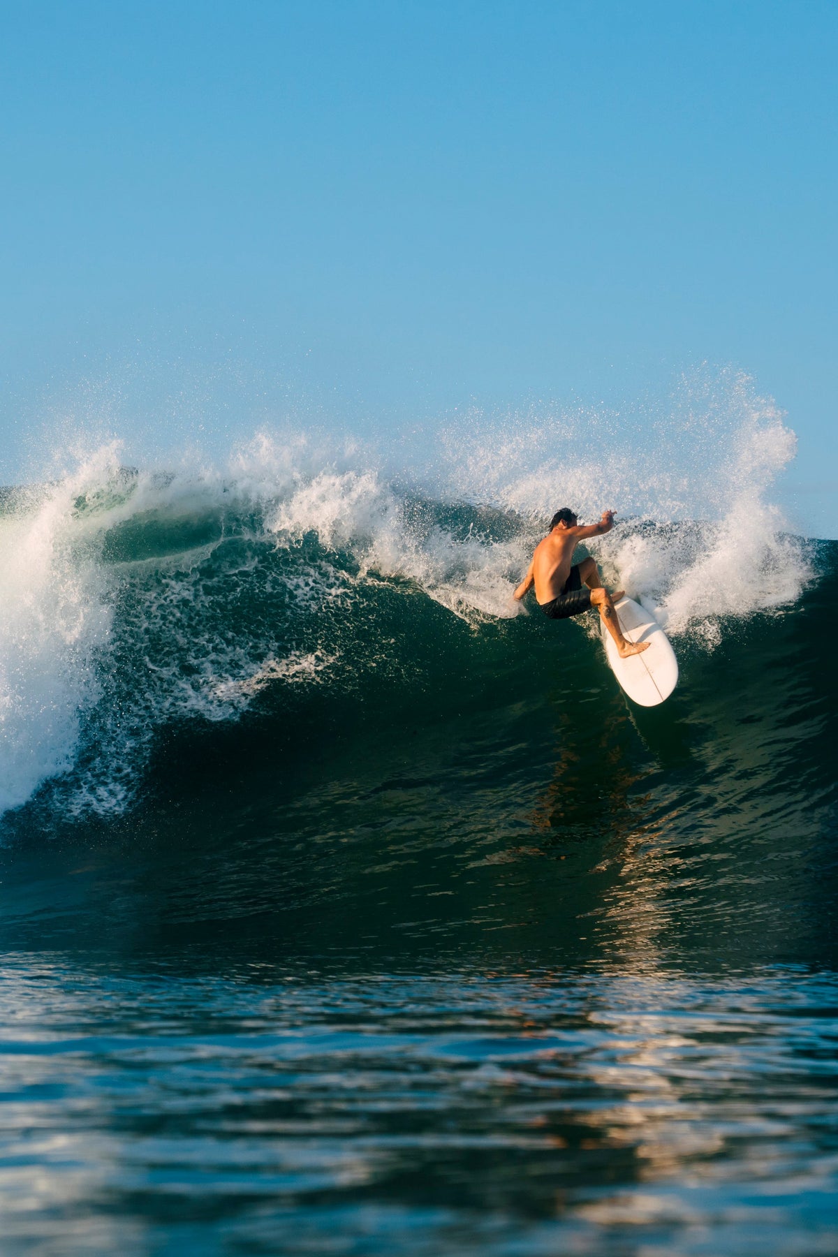 surfer riding a midlength doing a powerful turn, perfect waves in bali, midlengths for sale in bali